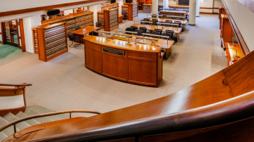 View from a staircase onto a large open atrium study area