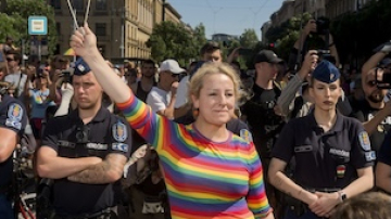 Person waves rainbow flag at march in Hungary
