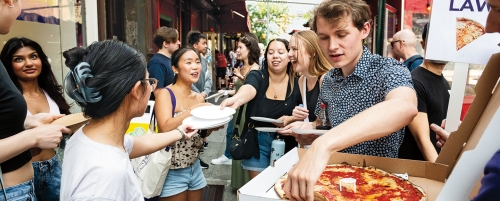 Student eating pizza