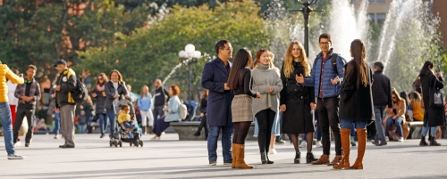 Students standing near fountain in Washington Square Park