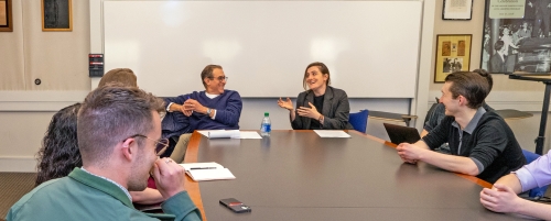 Barry Friedman and Emma Kaufman with students at a conference table