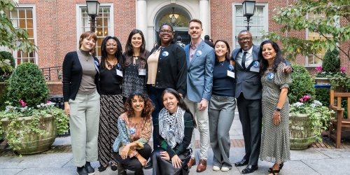 Bernstein Institute team posing outside of the main entrance to Vanderbilt Hall at NYU Law