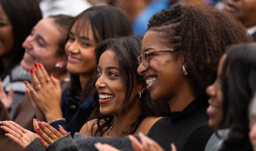Audience members applauding at an event