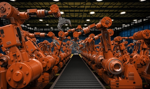 Robotic arms along a conveyor belt in a manufacturing facility