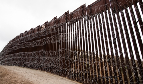 Layers of Concertina are added to existing barrier infrastructure along the U.S. - Mexico border near Nogales, AZ, February 4, 2019. Photo: Robert Bushell