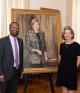 Troy McKenzie and Courtney O'Malley standing next to a portrait of Florence Davis