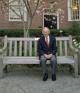 A man in a suit on a bench 