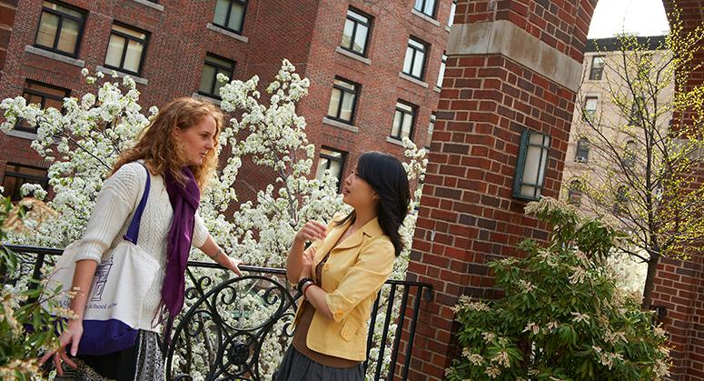 Students chat on the Vanderbilt Hall terrace, with D'Agostino Hall, one of the primary NYU Law residence halls in the background.