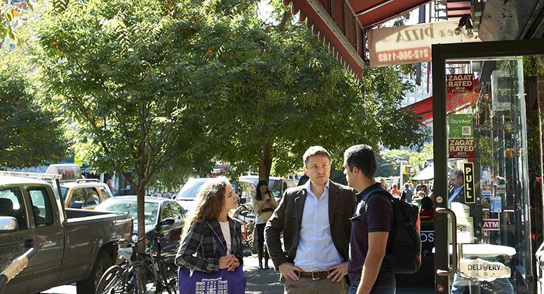 Students talking in front of pizza parlor in Greenwich Village