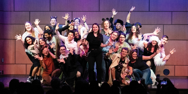 Scene of a group of students on stage for Law Revue