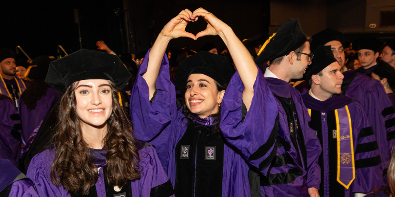 Graduate making a heart sign with her hands