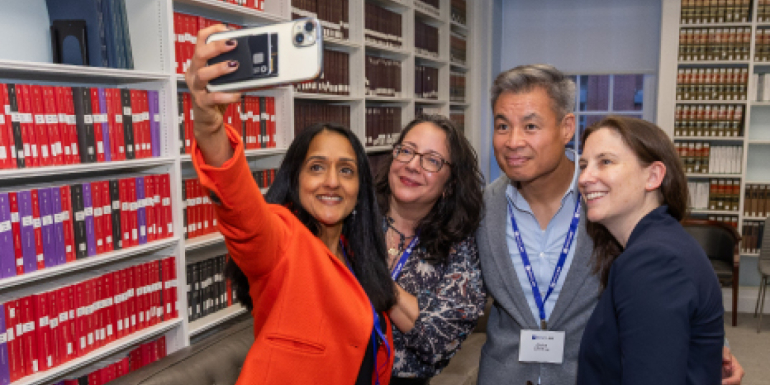 Vanita Gupta and other alumni taking a selfie