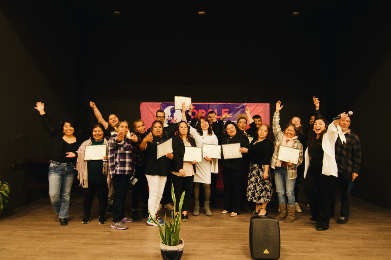 ORALE members holding up certificates and smiling