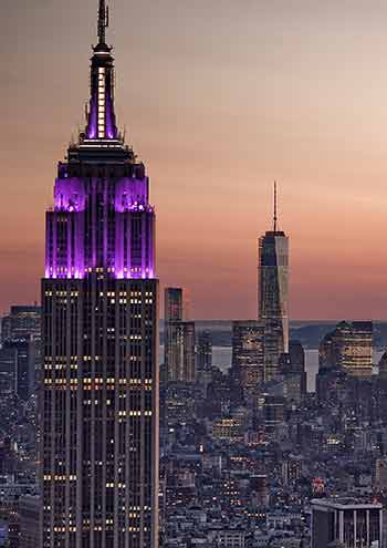 New York City skyline with Empire State Building lit in purple
