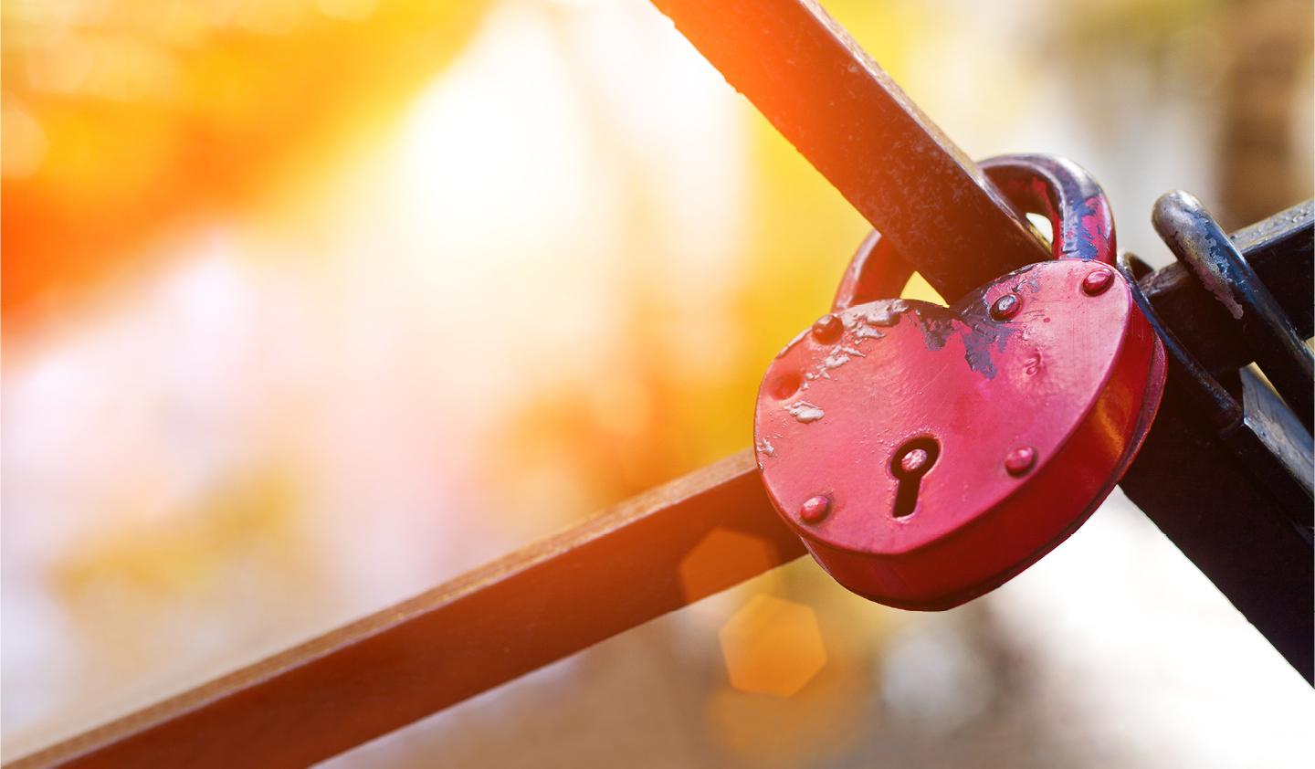 Lock shaped like heart with intersecting bars