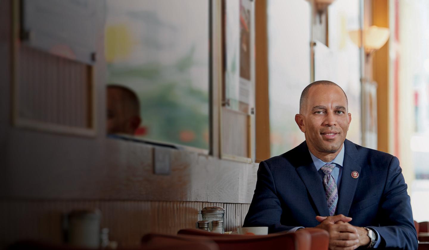 Hakeem Jeffries sitting at table in diner