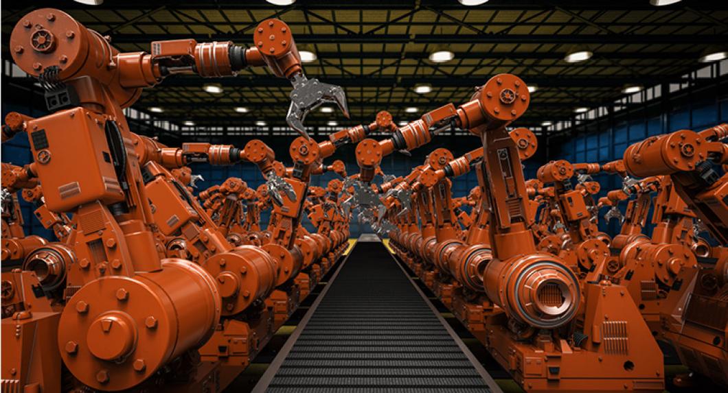 Robotic arms along a conveyor belt in a manufacturing facility