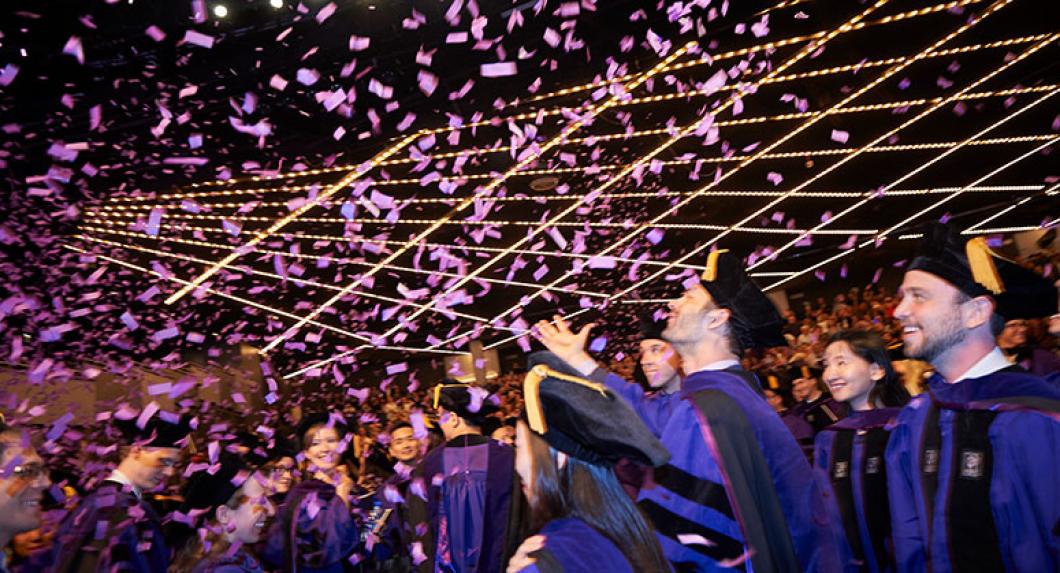 Graduating students being showered with confetti in the theater at Madison Square Garden 