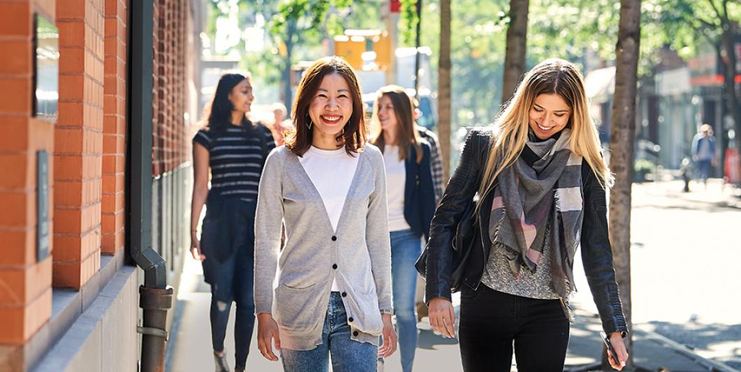 Students walking on sidewalk next to Furman Hall