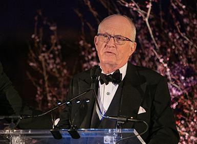 Charles Klein speaking at podium