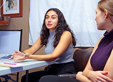 Mariana Lopez and Ola Topczewska at a table