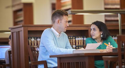 Two students sitting at library table