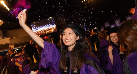 Graduate waving pom-pom
