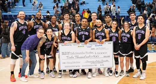 NYU Law team with big check and trophy, Deans' Cup