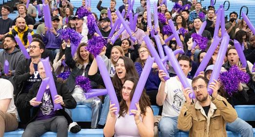 Spectators on bleachers at Deans' Cup basketball game