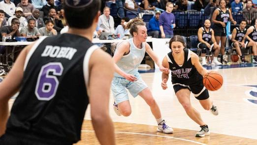 NYU Law player dribbles ball in Deans' Cup