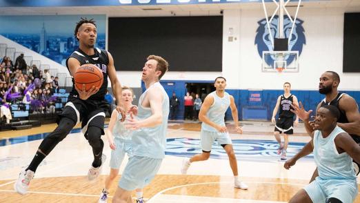 NYU Law player with ball in Deans' Cup game