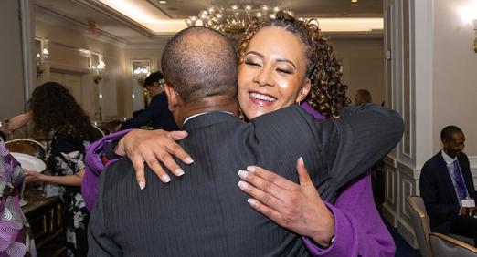 Lisa Boykin ’95 hugging Dean McKenzie ’00