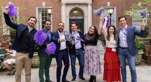 Alumni waving pom-poms in front of Vanderbilt Hall