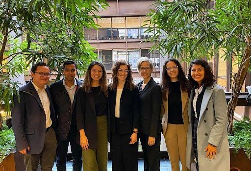 seven people wearing professional clothing smiling