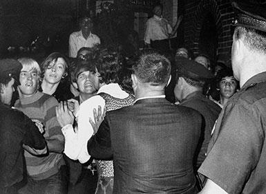 Stonewall Inn nightclub raid. Crowd attempts to impede police arrests outside the Stonewall Inn on Christopher Street in Greenwich Village.