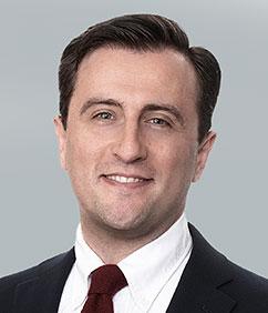Jack Samuel headshot with jacket and tie