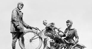 Black and white photo of Van Buren sisters with a motorcycle