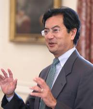 Kent Hirozawa speaking at a lectern