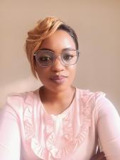 Black woman wearing glasses smiling at the camera