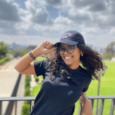 Yeabsira Asrat smiling and tipping a NYU Law hat