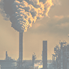 A large plume of emissions rising from a smokestack.