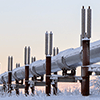 An oil pipeline running through a snowy landscape.