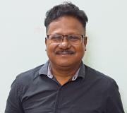 Man with short hair and a mustache smiling