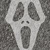 A halloween "scream" face on a grey-speckled background.