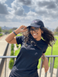 Yeabsira Asrat smiling and tipping a NYU Law hat