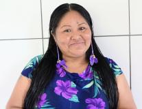 Woman with long dark hair smiling