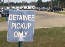 detainee pick up sign in parking lot of detention facility