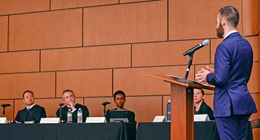 Abe Evans at lectern talking to judges