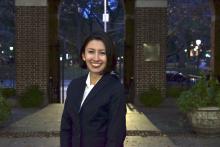 Mariana Munera smiling in the front yard of NYU School of Law Vanderbilt Hall