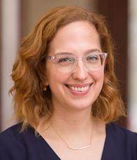 Woman in clear glasses, red hair